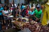Customers stand in line to buy unregulated meat from a street vendor during a beef shortage in Caracas, Venezuela, on Monday, Dec. 18, 2017.