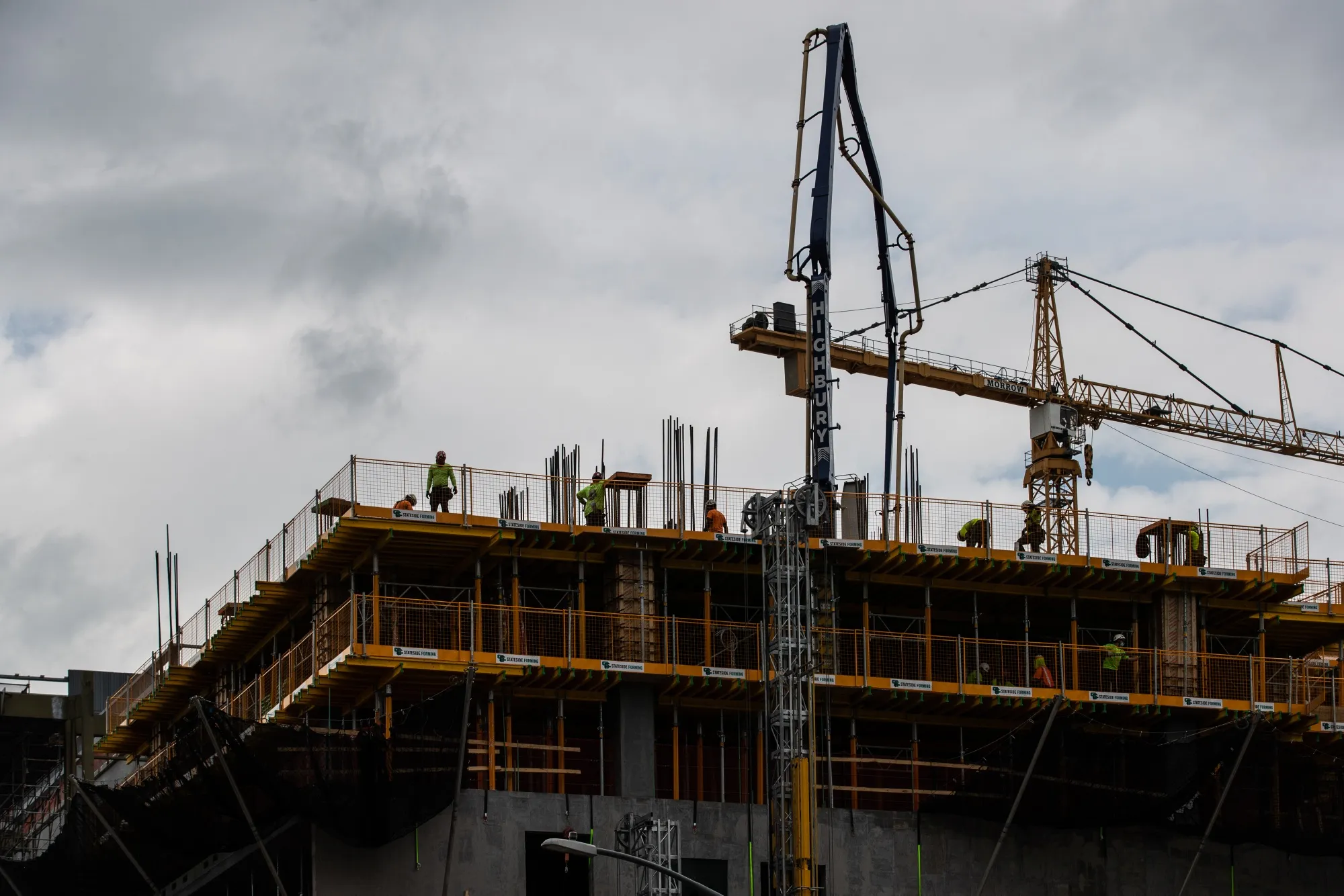 Construction workers atop a building under development on 11th Avenue in New York on June 11.