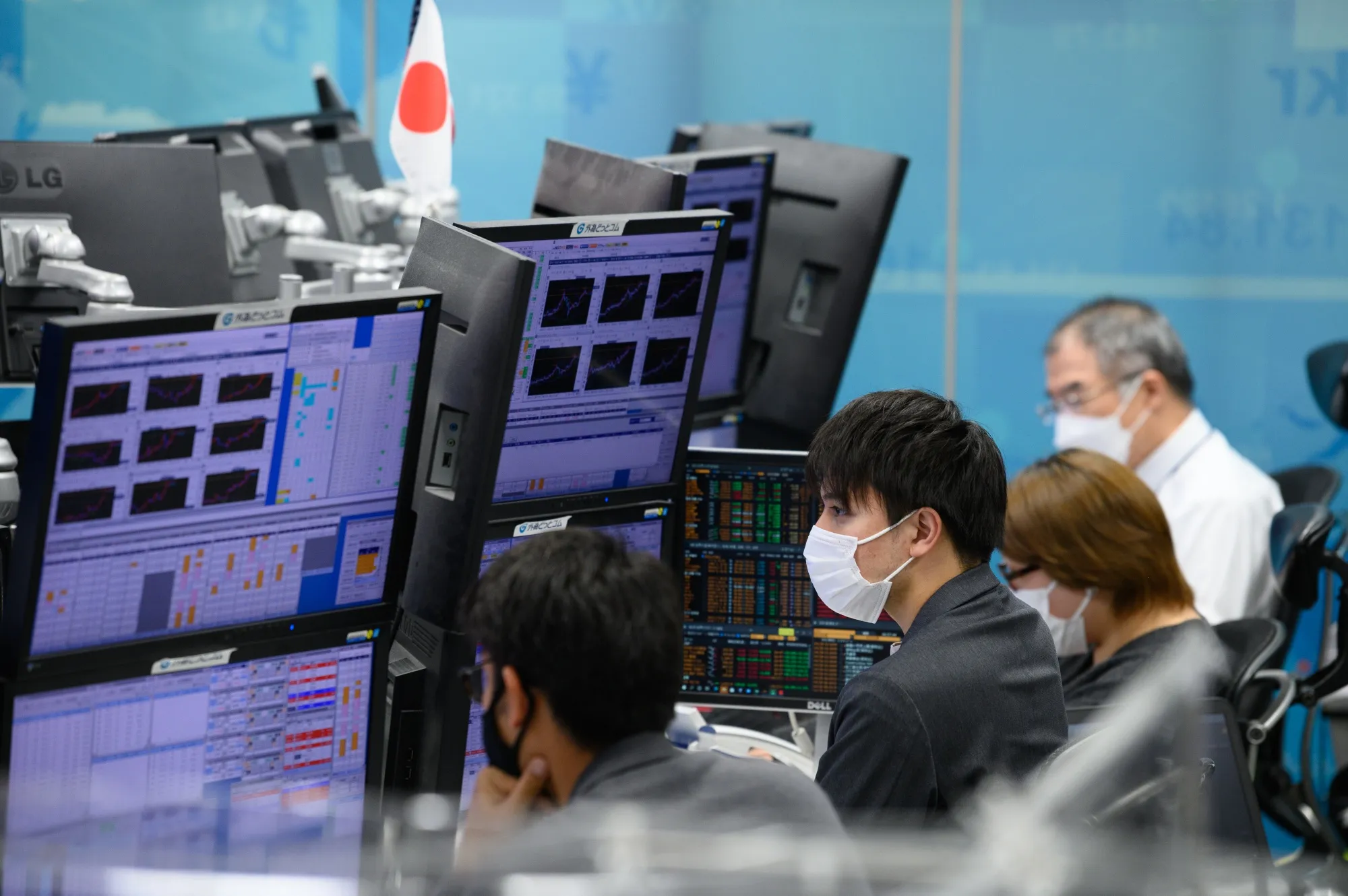 Dealers in the trading room at foreign exchange brokerage in Tokyo.