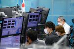 Dealers in the trading room at foreign exchange brokerage in Tokyo.