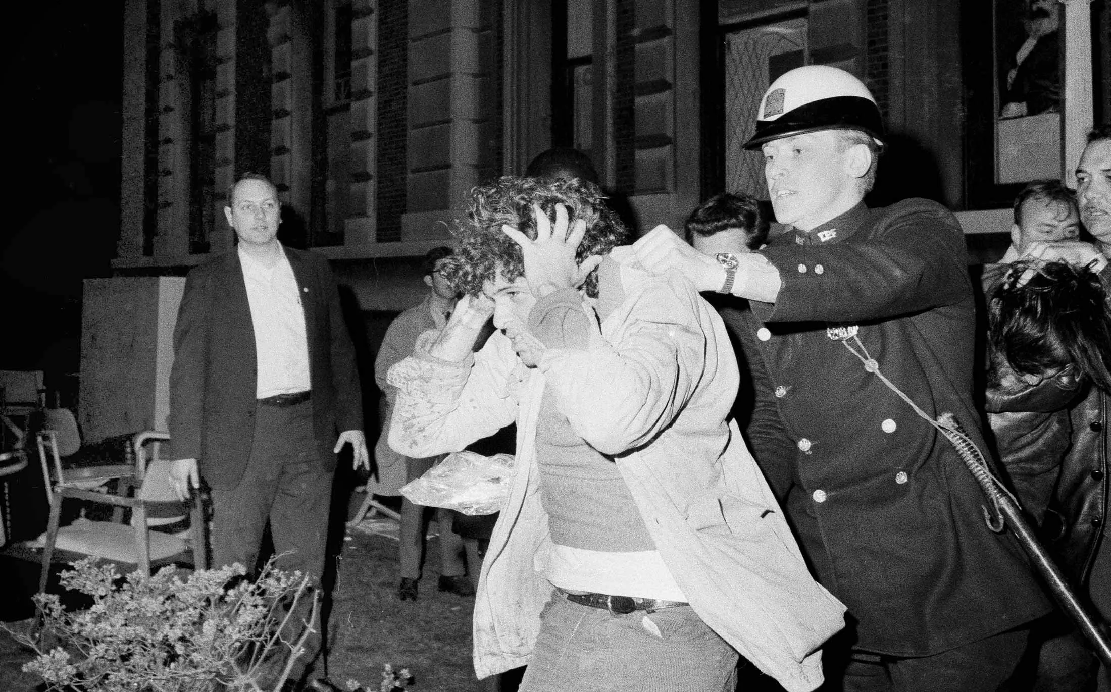 A student protester at Columbia University is forcibly removed from the campus on April 30, 1968, by New York City police.
