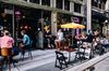 People sit outside during happy hour at the Oscar Wilde bar in New York, U.S., on Wednesday, June 10, 2020. New York streets got a little more congested this week as the city entered Phase 1 of its re-opening from the coronavirus-imposed lockdown.