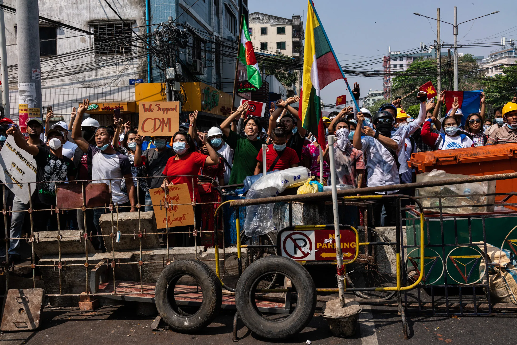 Anti-coup protesters gather behind a barricade in Yangon, Myanmar on Feb. 27.