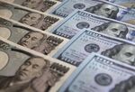 Japanese 10,000 yen and U.S. 100 dollar banknotes are arranged for a photograph in Tokyo, Japan.