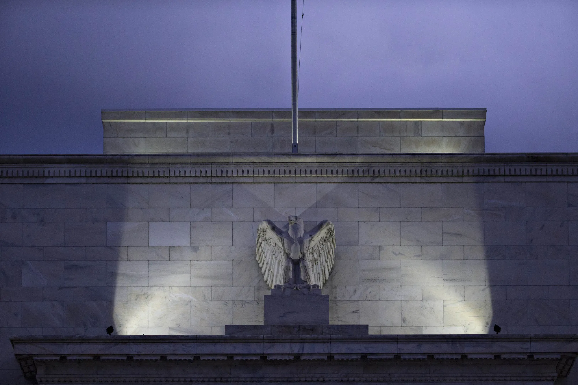 An eagle sculpture stands on the façade of the Marriner S. Eccles Federal Reserve building in Washington, D.C.
