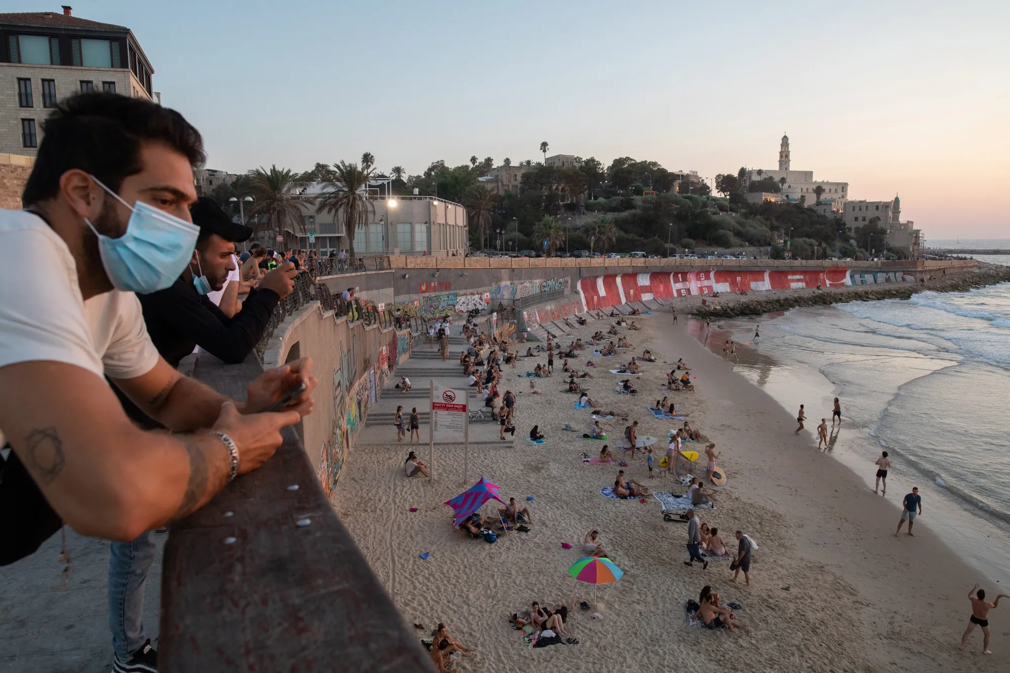 People wearing protective masks in Tel Aviv.