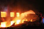Residents and firefighters fight a garment factory blaze in Savar, Bangladesh