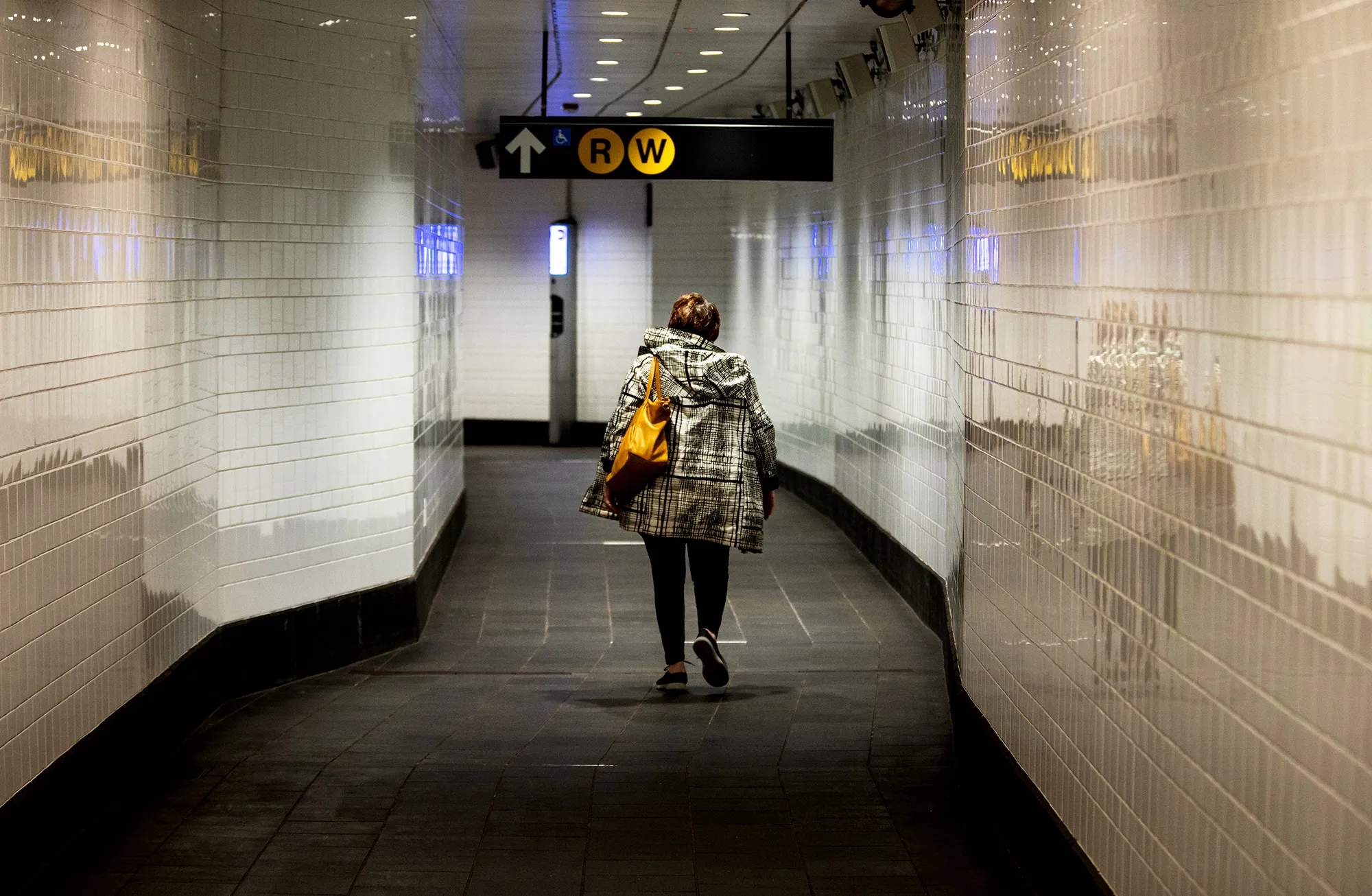 A commuter walks in a subway station in New York.