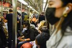 Commuters wear protective masks while riding&nbsp;a subway in New York on May 25.