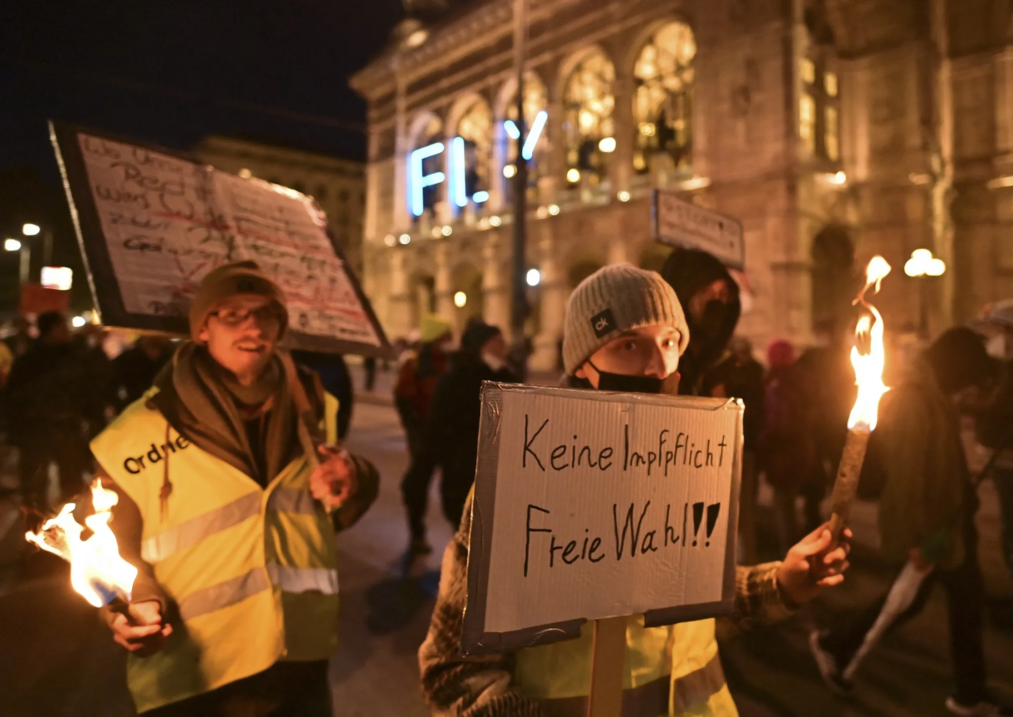 Demonstrators carry torches and a "No Compulsory Vaccination" sign during a rally held by Austria's far-right Freedom Party&nbsp;in Vienna, on Nov. 20.