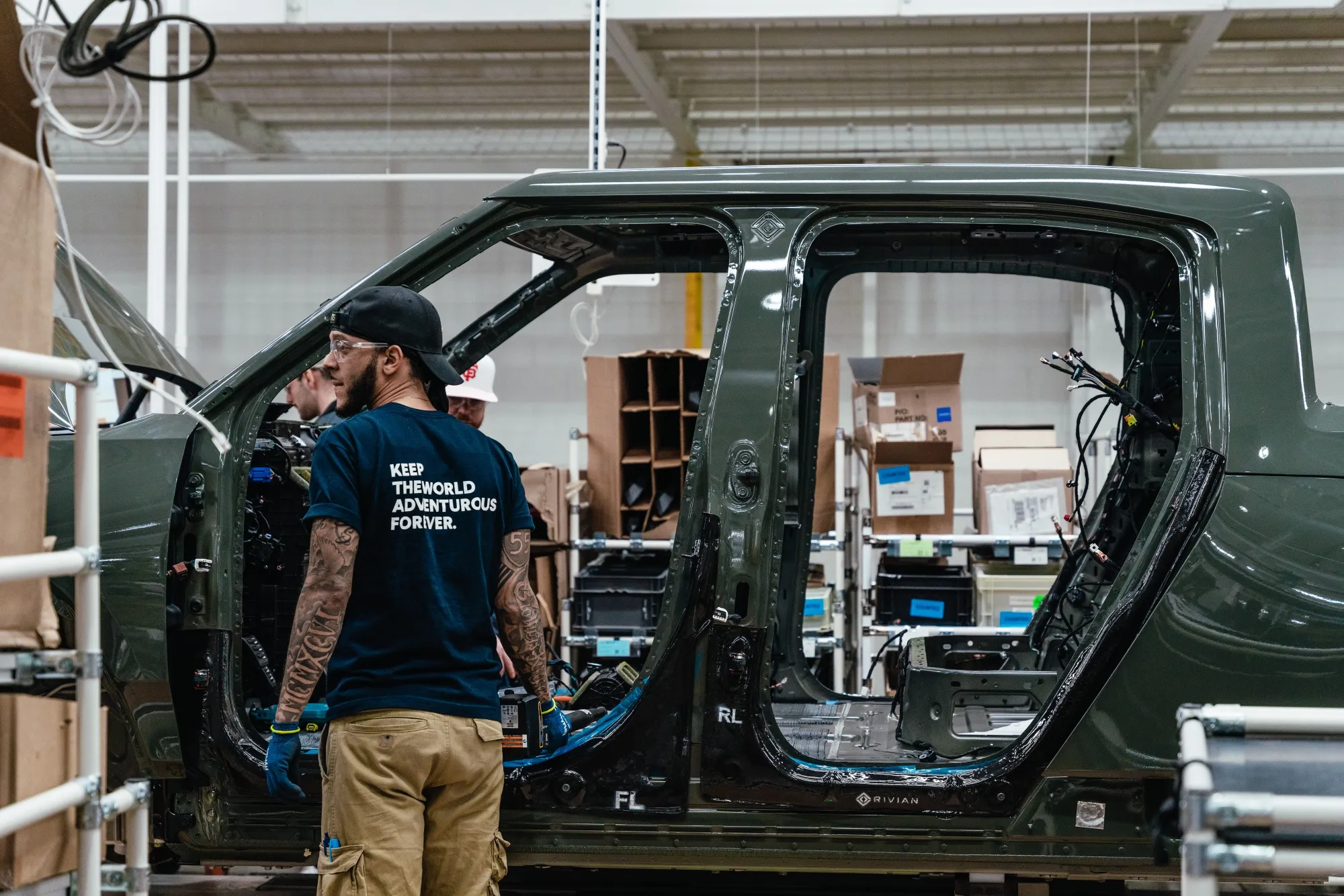 Workers assemble&nbsp;components of a Rivian electric vehicle&nbsp;at the company's manufacturing facility in Normal, Illinois.