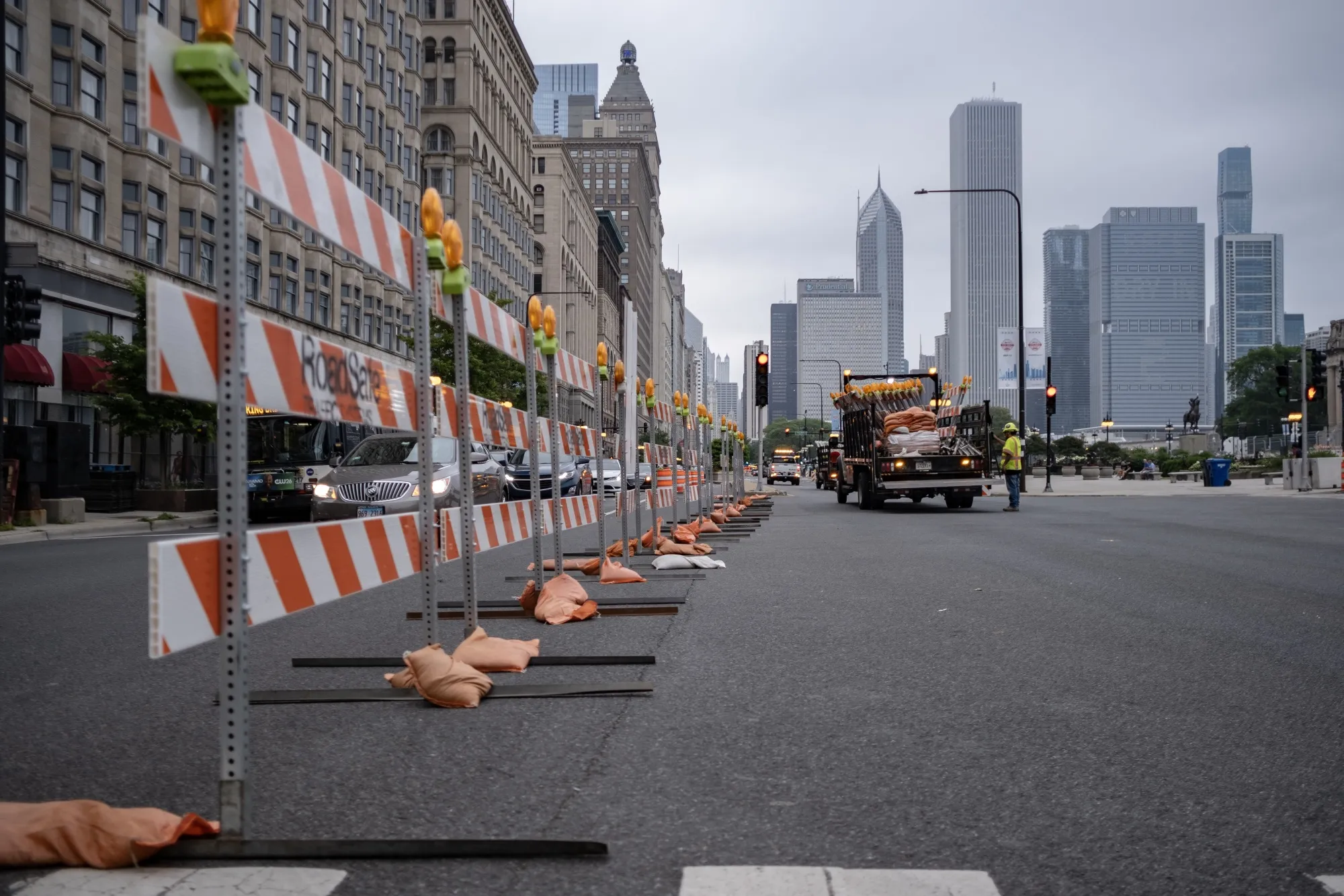 Workers place roadblocks on Michigan Ave in downtown Chicago to deter traffic from the newly built Nascar street course on June 29.