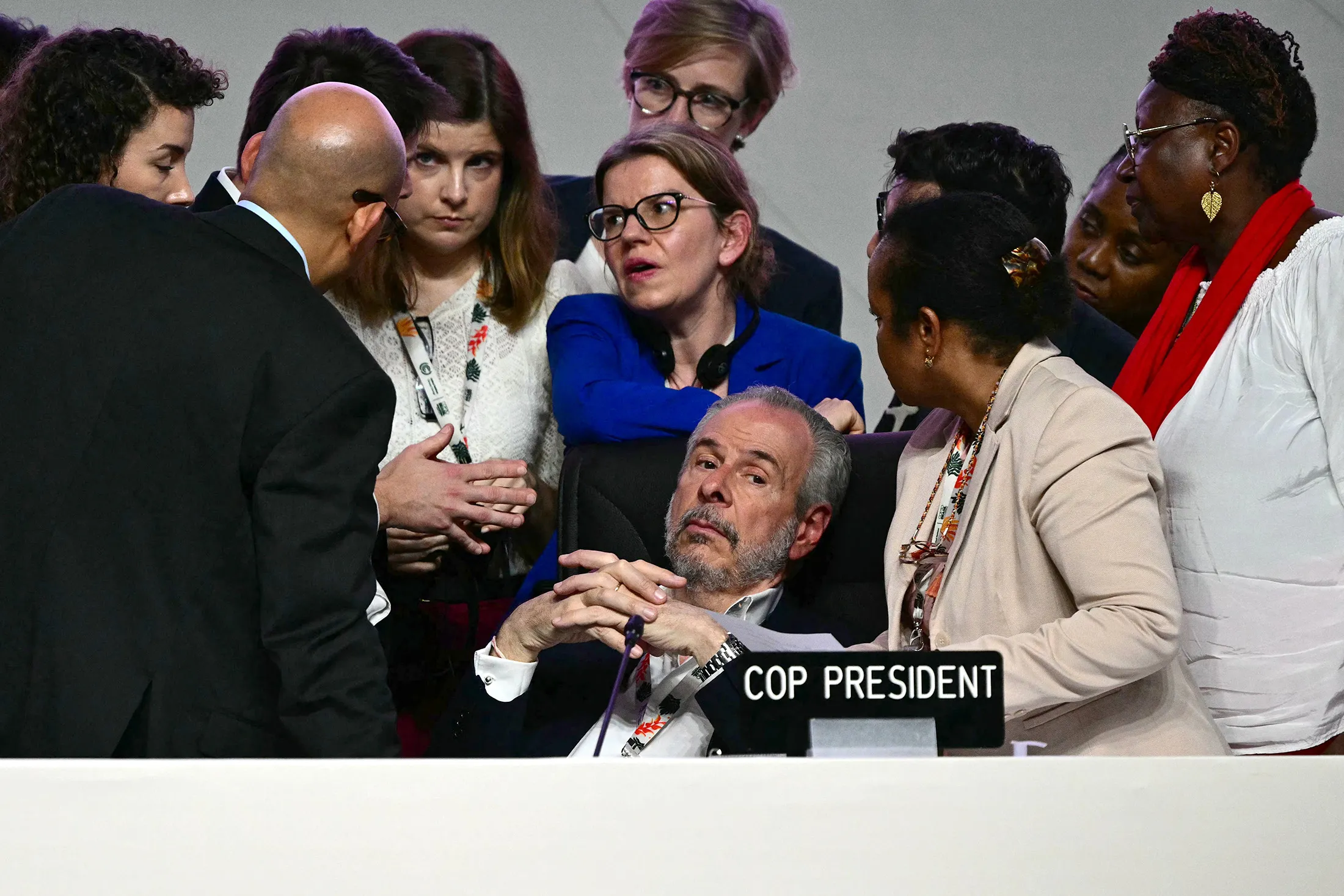 COP30 President André Corrêa do Lago, center, listens to advisers&nbsp;during the closing&nbsp;plenary session at COP30 on Nov. 22.