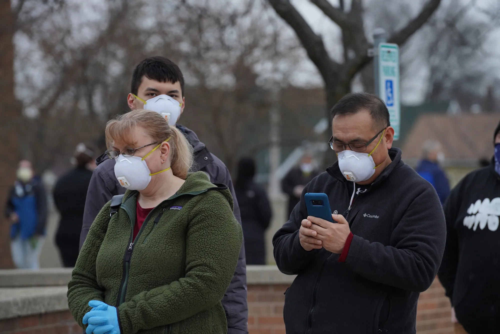Voters wearing protective masks stand in line to cast ballots at a polling station in Milwaukee, Wisconsin, on&nbsp;April 7.