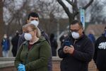 Voters wearing protective masks stand in line to cast ballots at a polling station in Milwaukee, Wisconsin, on April 7.