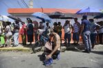 Puerto Rican residents of San Juan wait in line people affected by Hurricane Maria wait in line at Barrio Obrero to receive supplies from the National Guard.