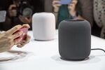 An attendee takes photographs of the Apple Inc. HomePod speakers displayed during the Apple Worldwide Developers Conference (WWDC).