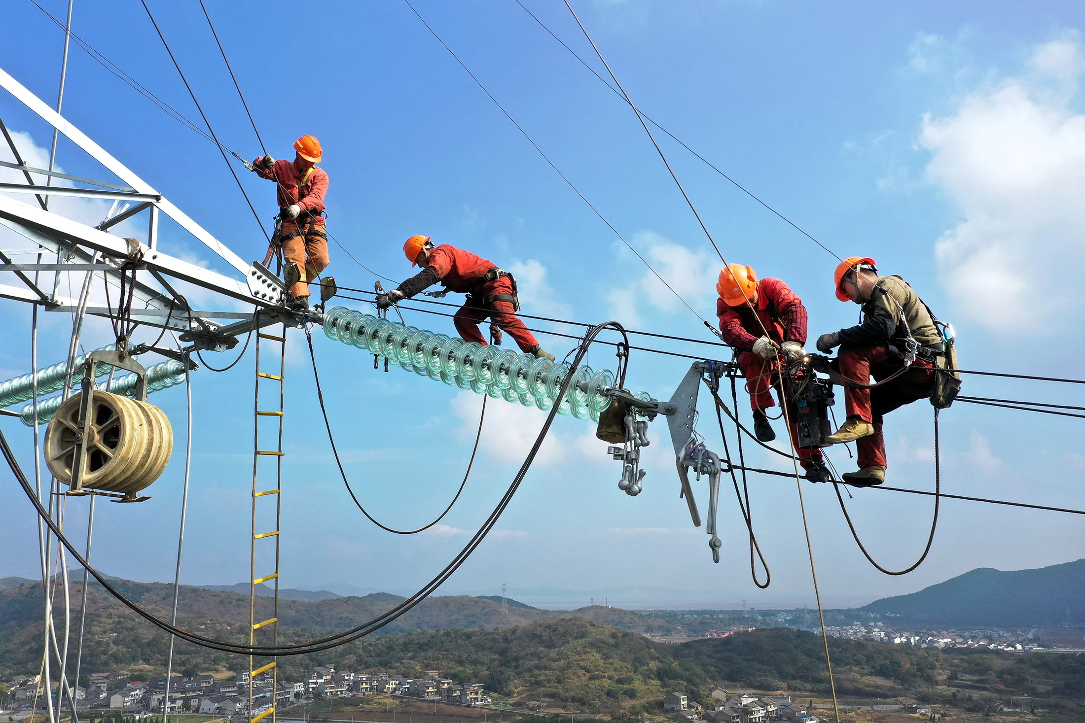 Electricians work on a transmission tower in Zhejiang Province on Dec. 10.