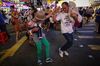 People dance along to a karaoke performance on Sai Yeung Choi Street. 