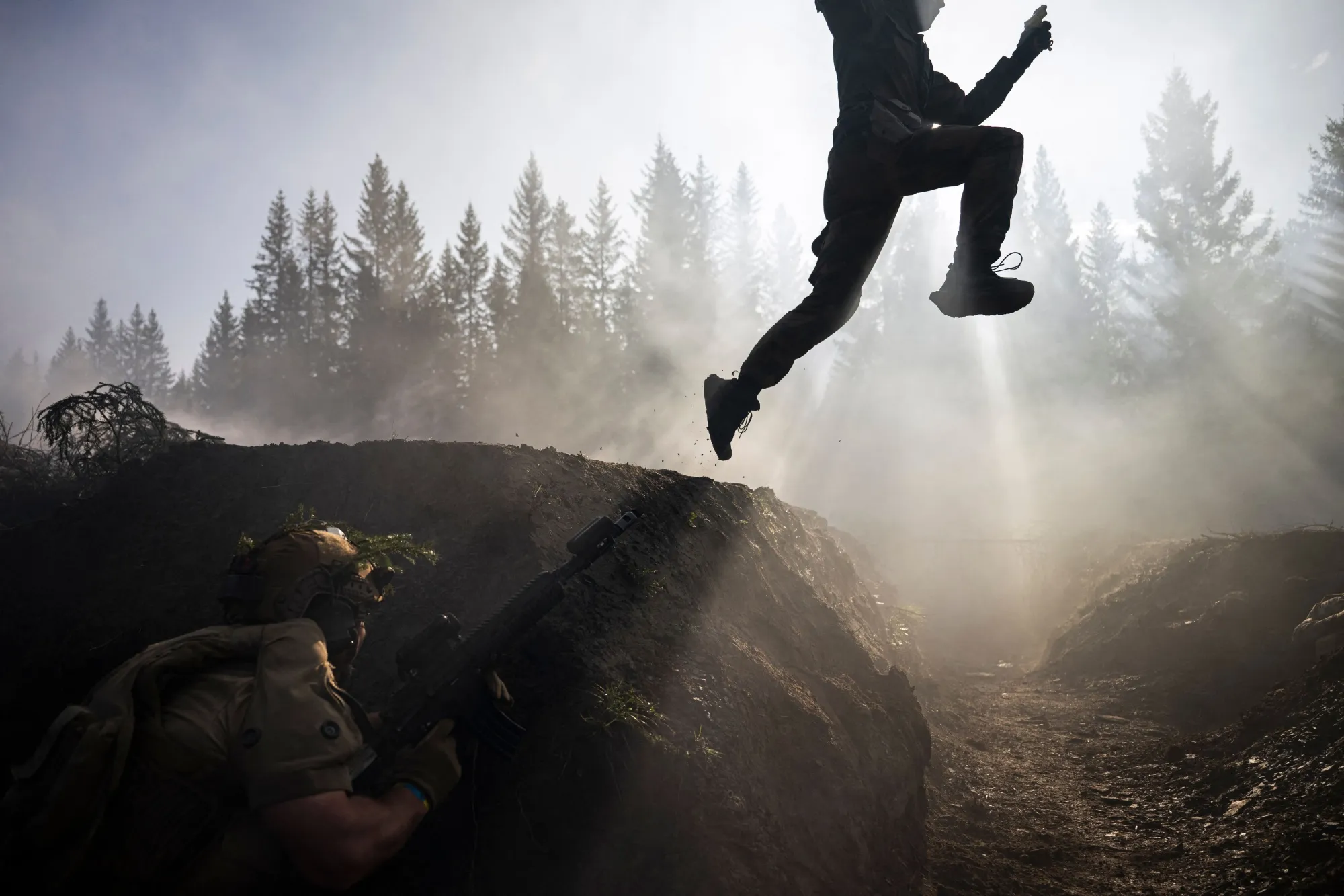 An instructor&nbsp;jumps above a Ukrainian soldier during a blank fire exercise in Trondheim, Norway.&nbsp;