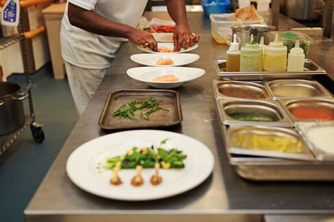 A prisoner puts the finishing touch to dishes at the Clink restaurant.