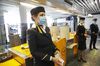 Lufthansa crew hold sachets of disposable handwipes at Frankfurt Airport.