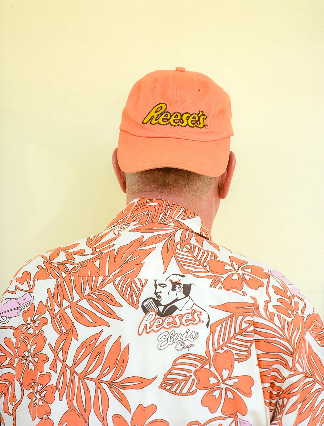 Brad Reese, in a Reese's branded cap and aloha shirt with his back turned to the camera