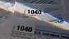 U.S. Department of the Treasury Internal Revenue Service (IRS) 1040 Individual Income Tax forms for the 2016 tax year are arranged for a photograph in Tiskilwa, Illinois, U.S., on Monday, Dec. 18, 2017. This week marks the last leg of Republicans\' push to revamp the U.S. tax code, with both the House and Senate planning to vote by Wednesday on final legislation before sending it to President Donald Trump.