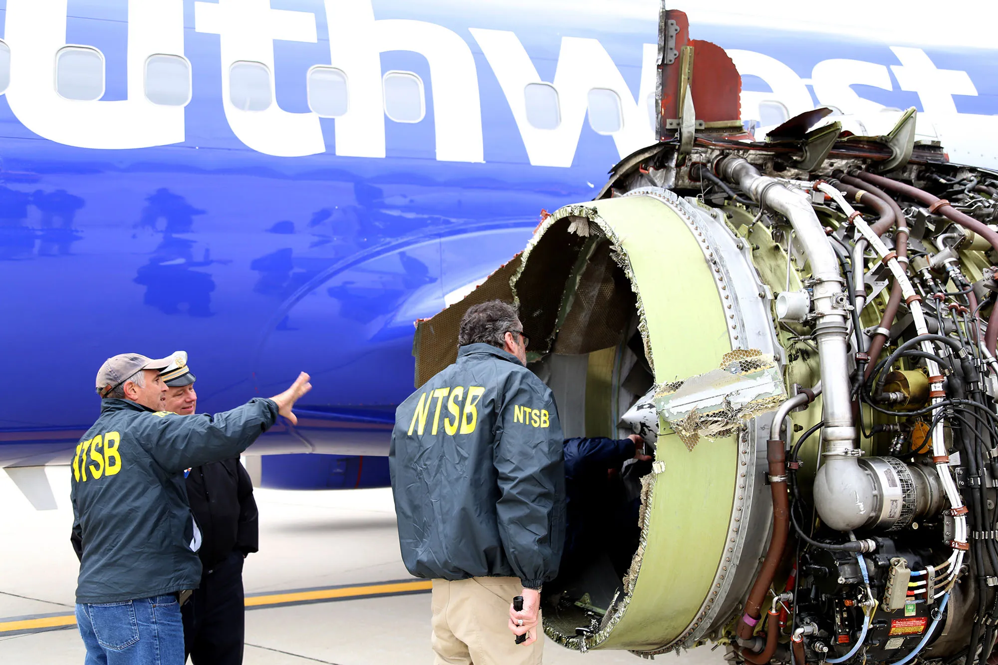 NTSB investigators examine damage to the engine on Southwest Airlines Flight 1380 on April 17, 2018.