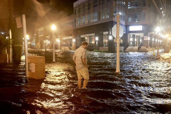 Surge waters flood a street in Fort Myers, Florida, on Oct. 9.  