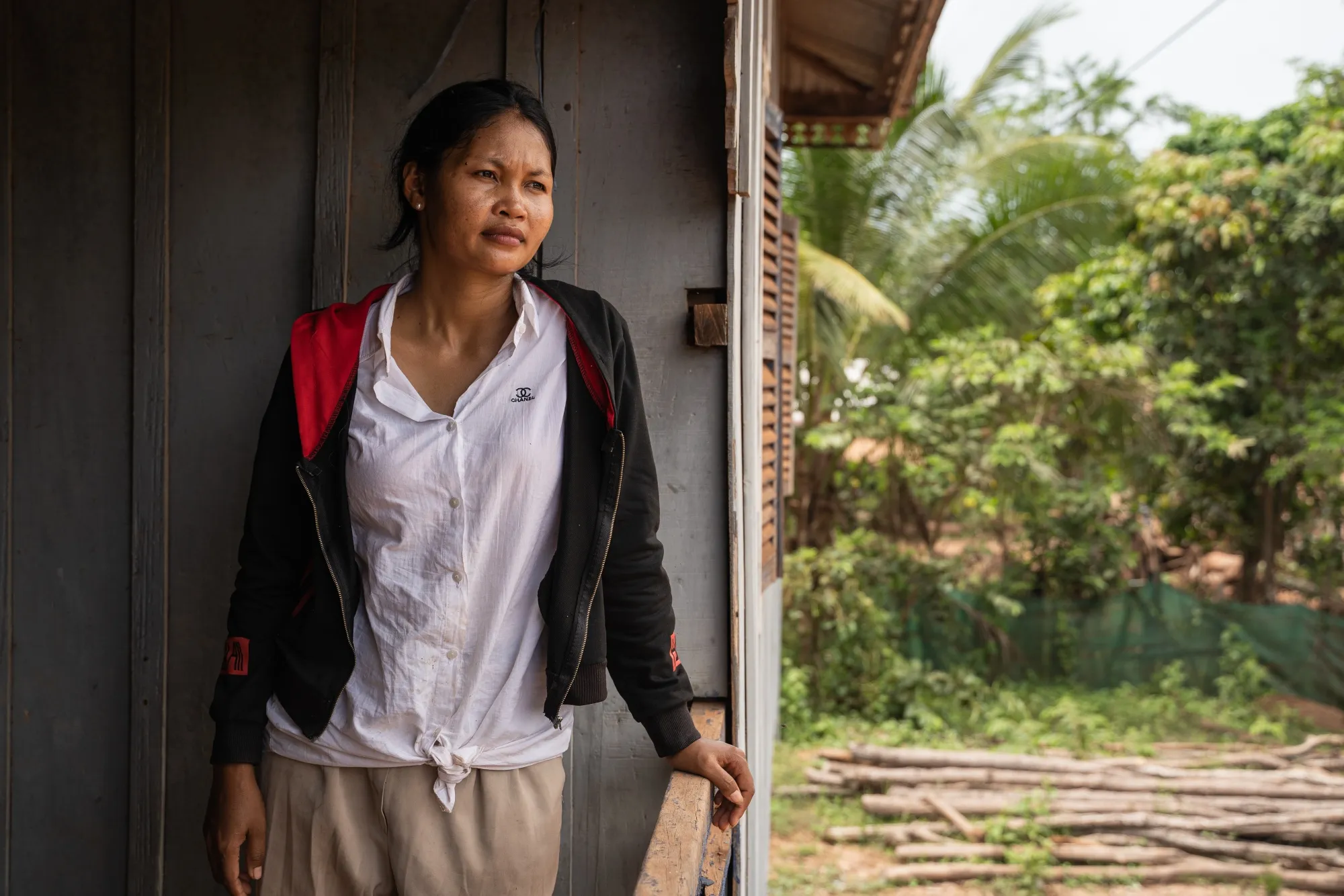 Suy Sokna at her sister-in-law’s house in central Cambodia. The 32-year-old storekeeper says she was pressured to sell her own home to repay a microfinance loan she signed with a thumbprint because she can barely read or write. 