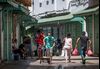 Pedestrians wearing protective masks pass through a street in Rabat.