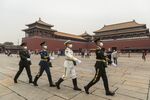 Members of the People's Liberation Army honor guards march past the Wumen Gate of the Forbidden City in Beijing.