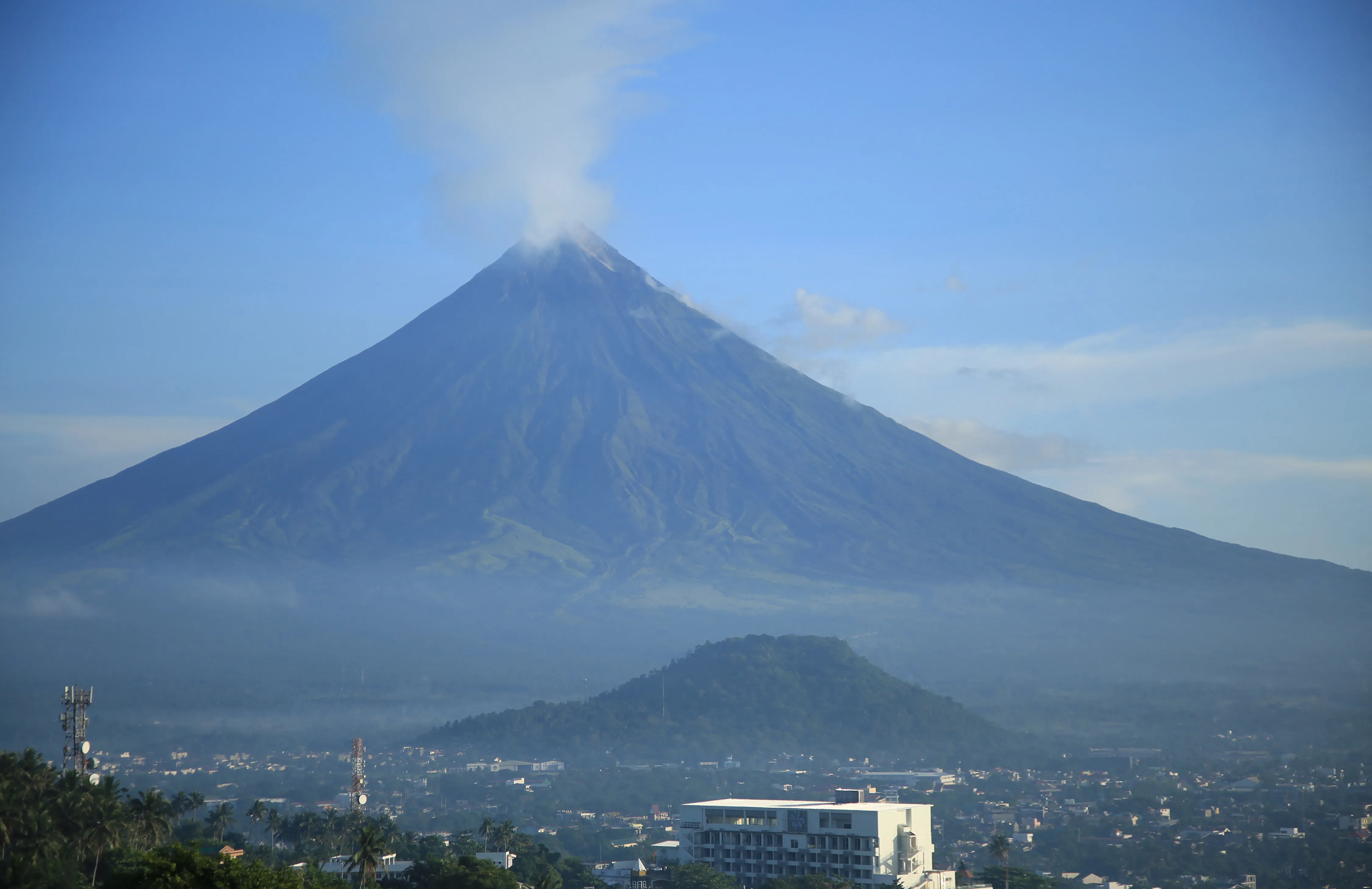 Mayon volcano spews white smoke in Legaspi City, Albay province, on June 7.