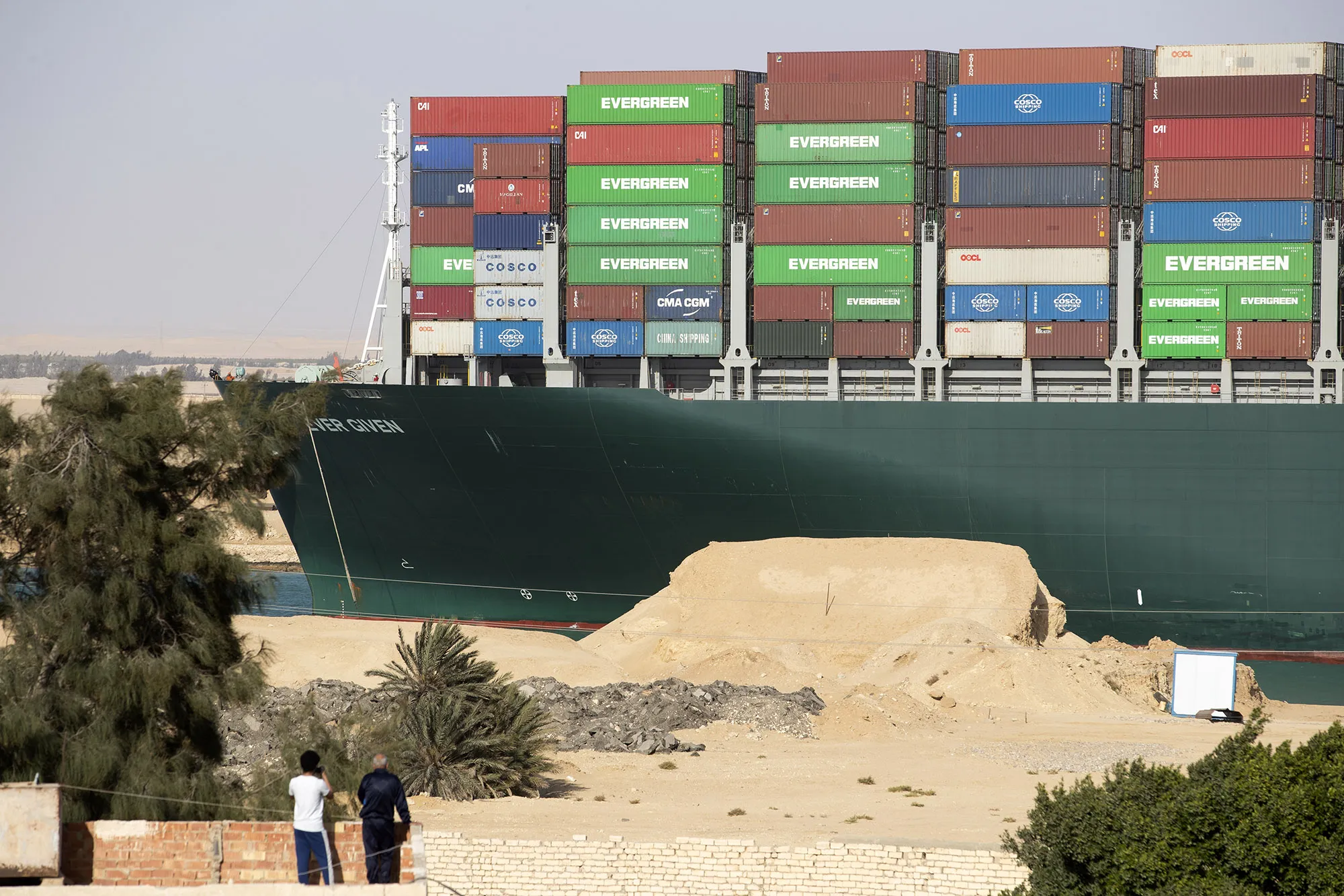 People watch as the 'Ever Given' is refloated, unblocking the Suez Canal on March 29.