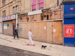 Residents pass boarded-up closed businesses in Weston-super-Mare, UK.