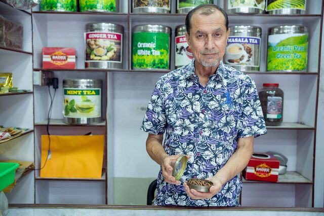 Bastola stands in front of the shelves in his shop in Kathmandu’s trendy Thamel neighborhood in July.