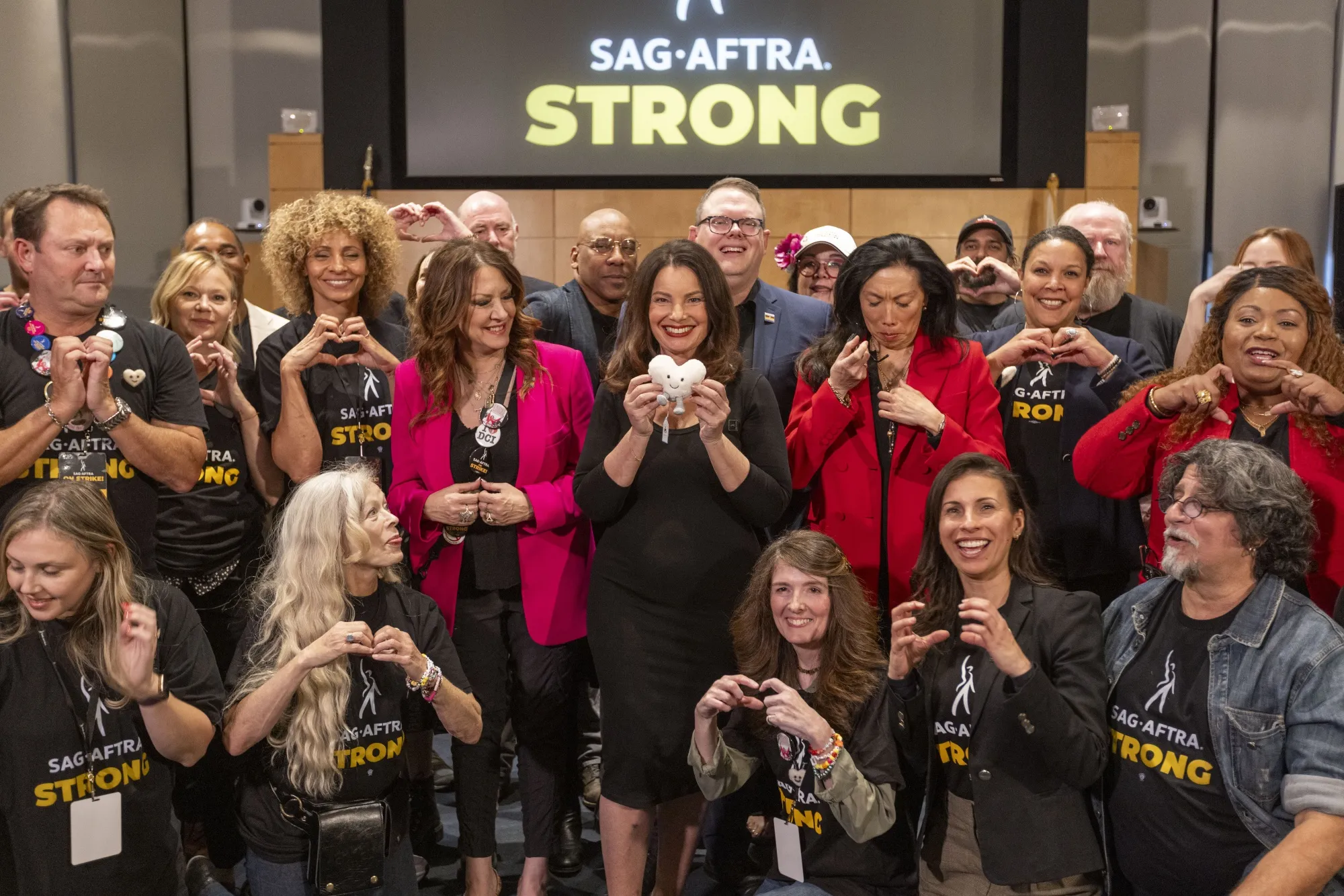 Fran Drescher, president of SAG-AFTRA, center, and other members of the negotiating team pose for photographs in Los Angeles&nbsp;on Friday, Nov. 10.