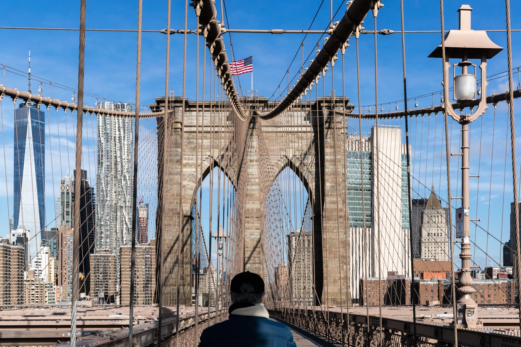 A pedestrian walks&nbsp;across the Brooklyn Bridge in New York on April 1.