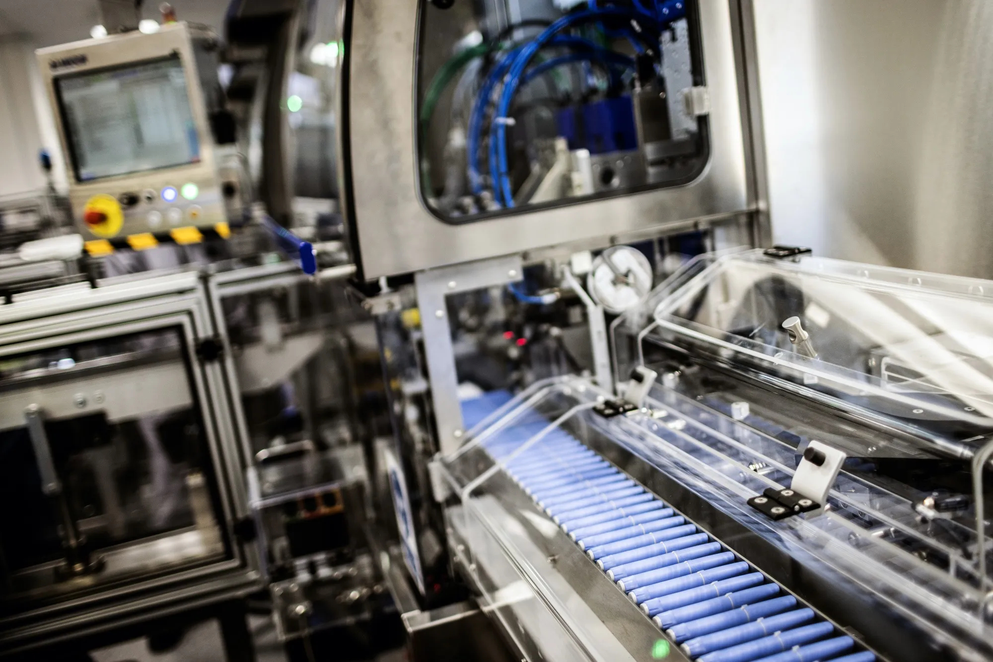 Injection pens move along a conveyor at the Novo Nordisk A/S production facilities in Hillerod, Denmark.