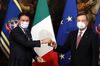 Giuseppe Conte hands a bell to Mario Draghi during a handover ceremony at Chigi Palace in Rome, Feb. 13.
