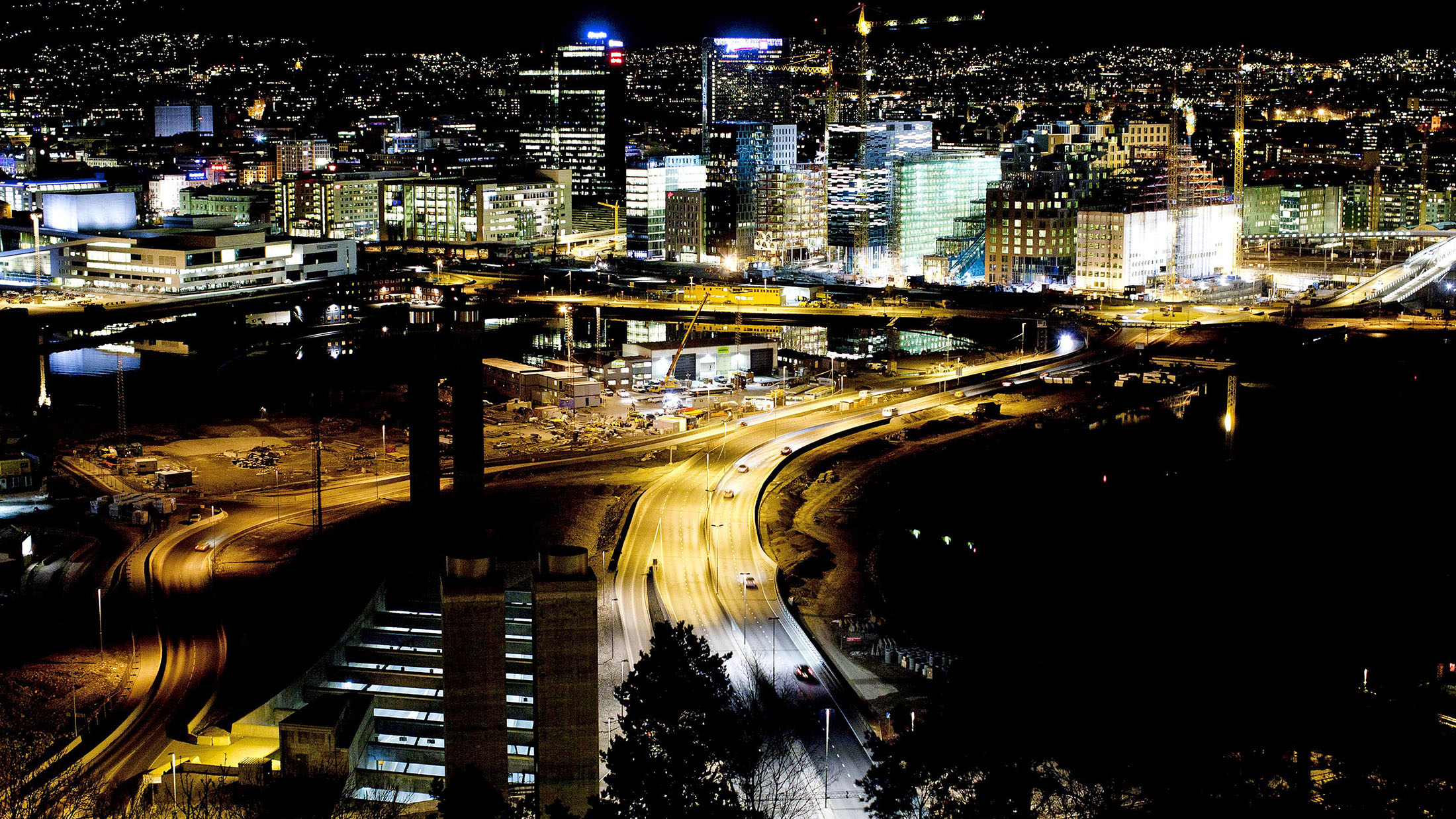 The city center skyline stands illuminated at night, seen from the Ekeberg hill, in Oslo.
