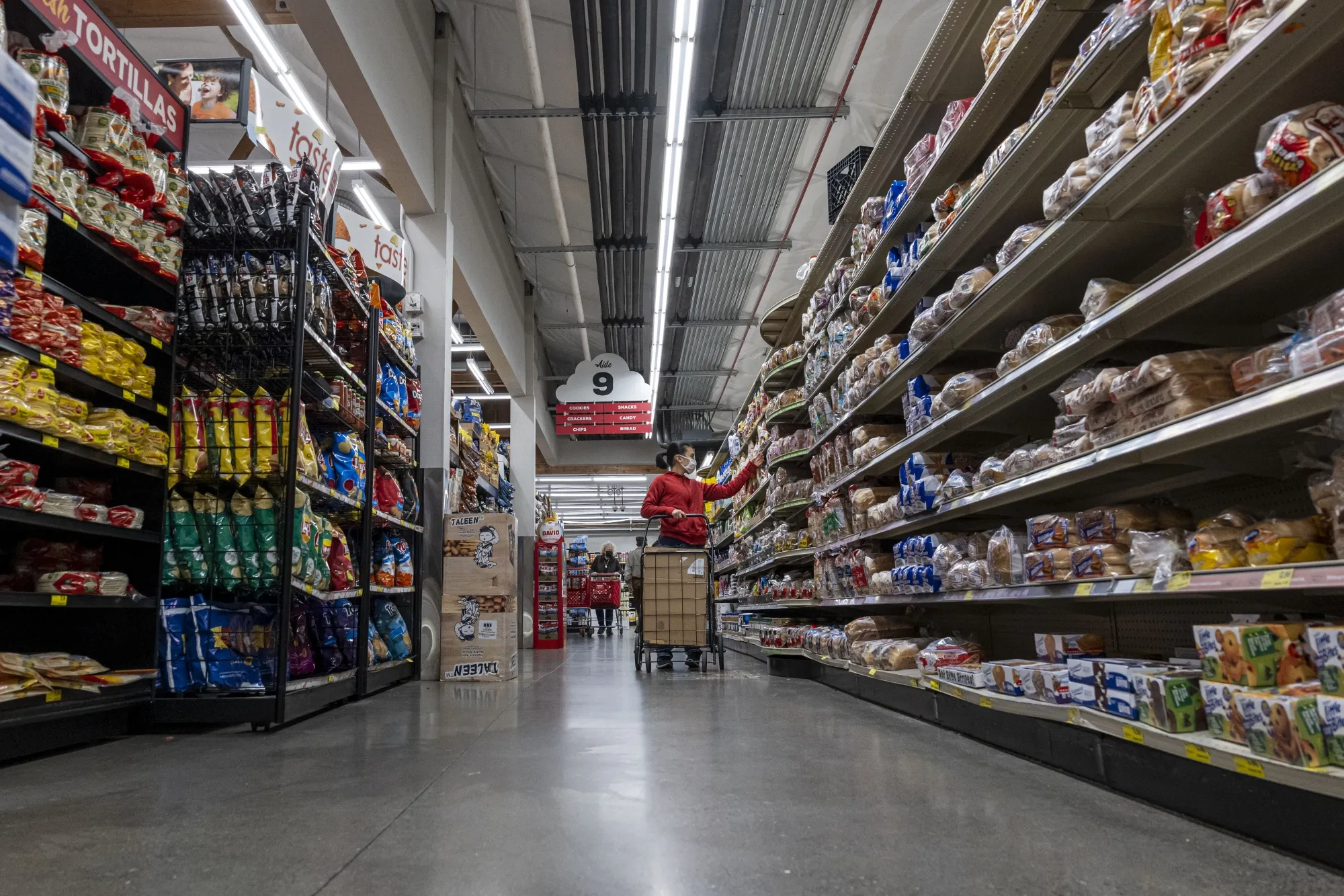 A customer shops for groceries at a store in San Francisco, California.
