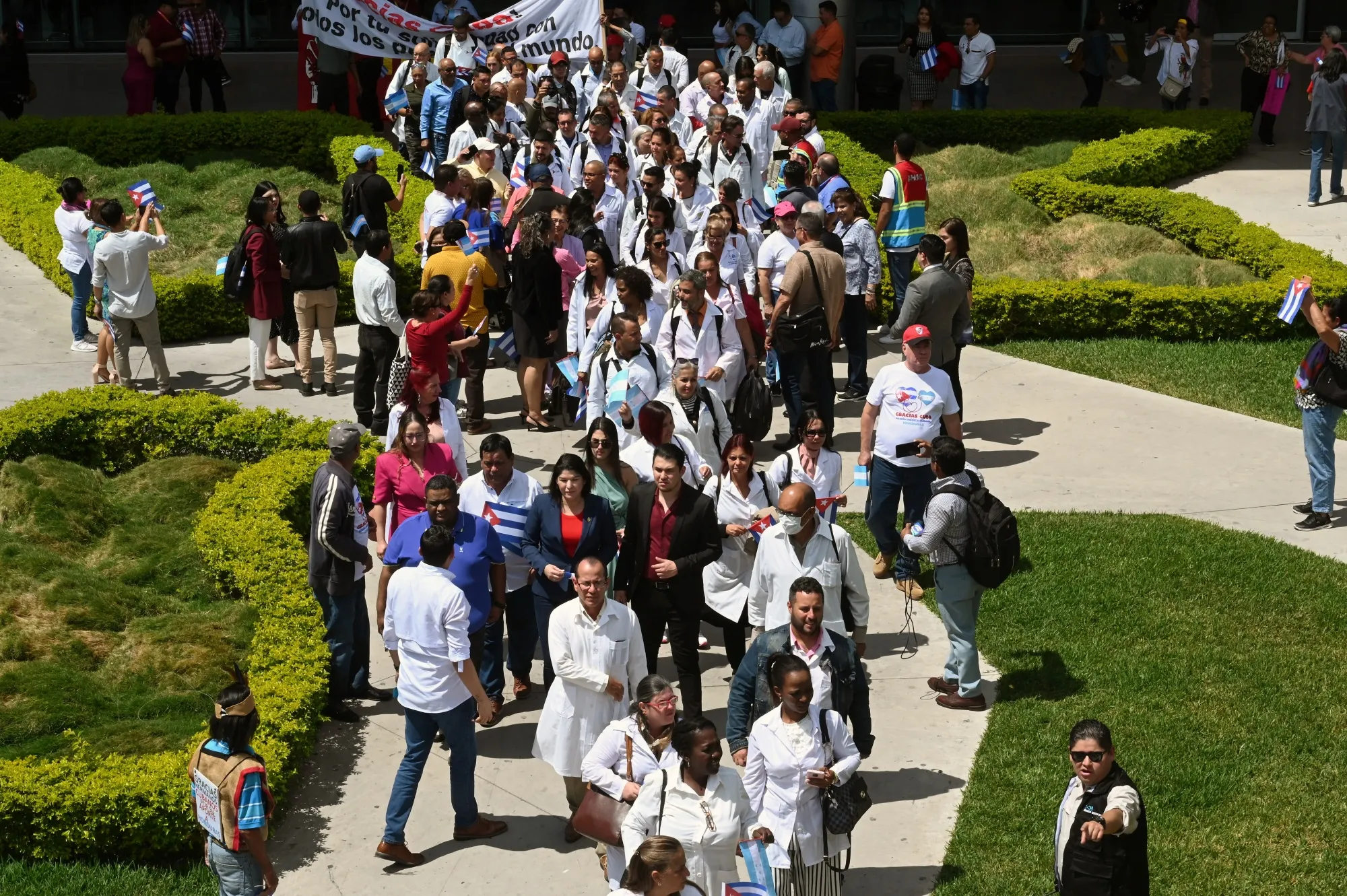 Cuban doctors walk to a bus at Palmerola International Airport near Tegucigalpa, Honduras in February 2024.