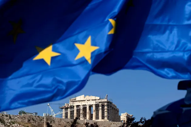 The Parthenon is seen beneath a European Union flag on the Acropolis of Athens