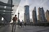 Pedestrians walk along an elevated walkway in the Lujiazui Financial District in Shanghai, China, on Monday, Sept. 4, 2017. The Chinese central bank\'s tight leash on liquidity is straining the bond market, with the benchmark sovereign yield climbing to near the highest level since April 2015.