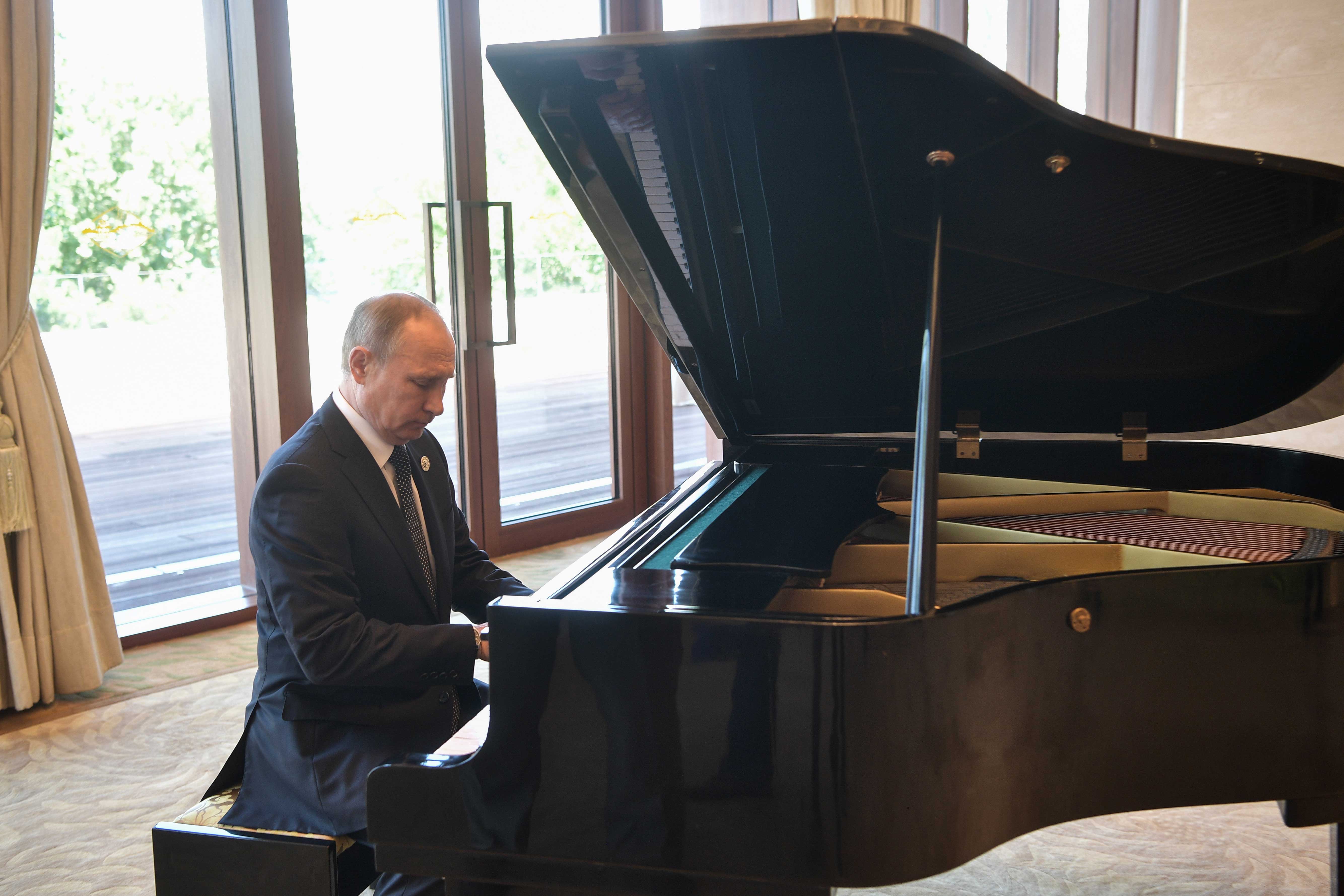 Russian President Vladimir Putin plays the grand piano ahead of a meeting with China's President Xi Jinping at the Diaoyutai State Guesthouse in Beijing, China.
