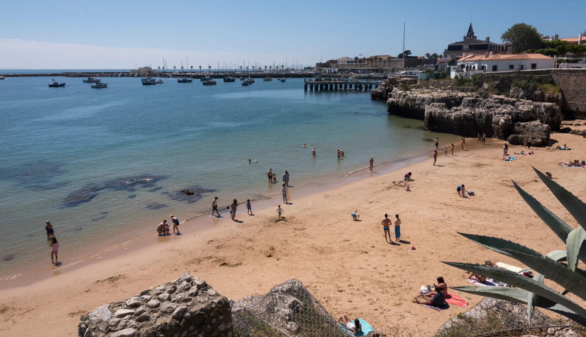 People on the beach at Praia da Rainha in Cascais.