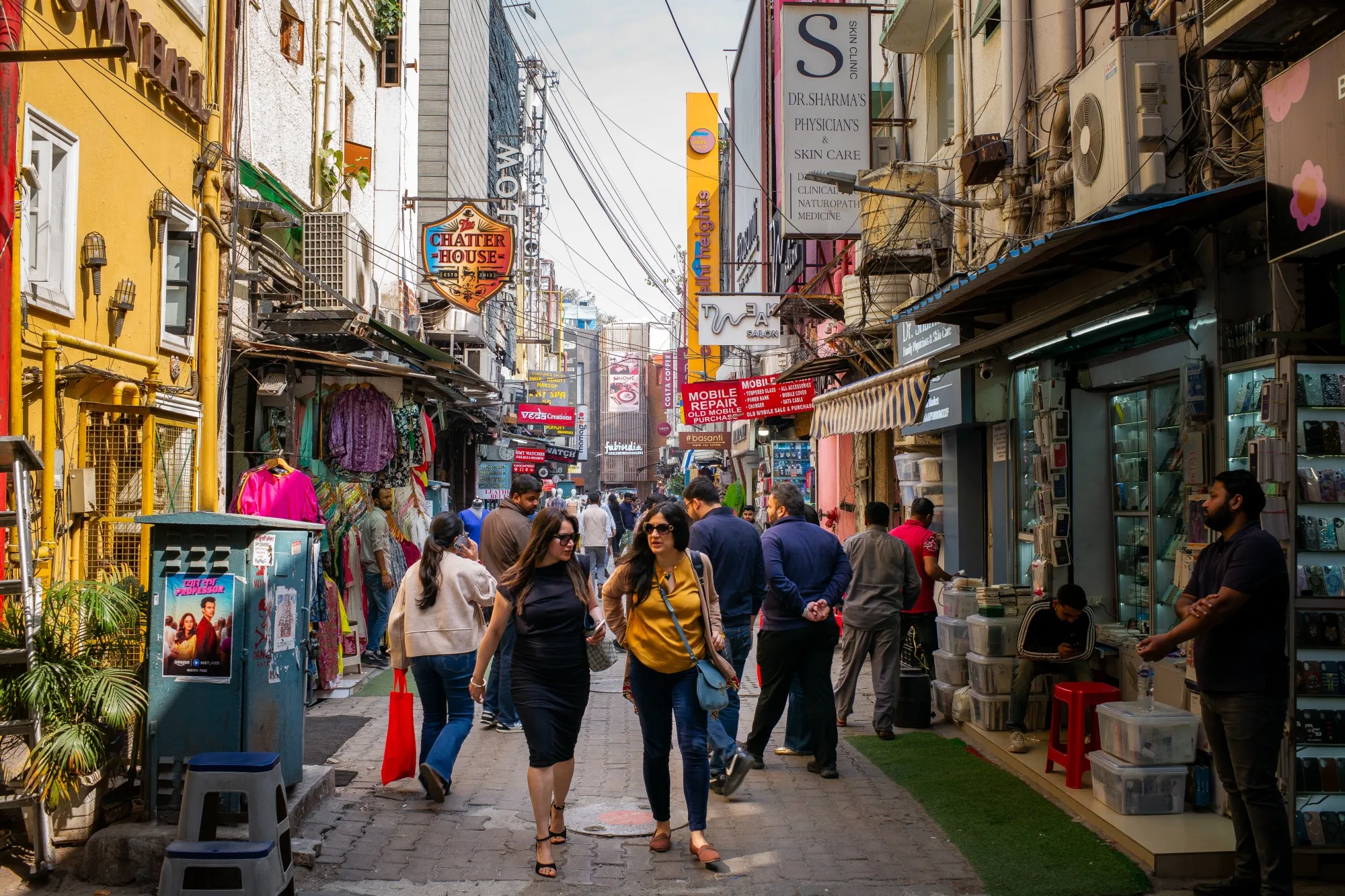 Pedestrians pass stores in New Delhi.