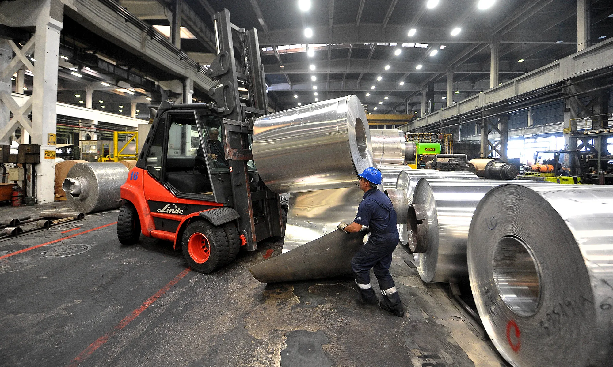 A worker secures a roll of sheet aluminum at a plant in Sevojno, Serbia.